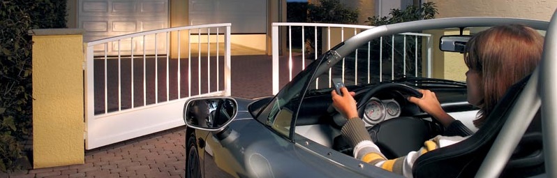 a picture of a woman in a car with a gate opening 